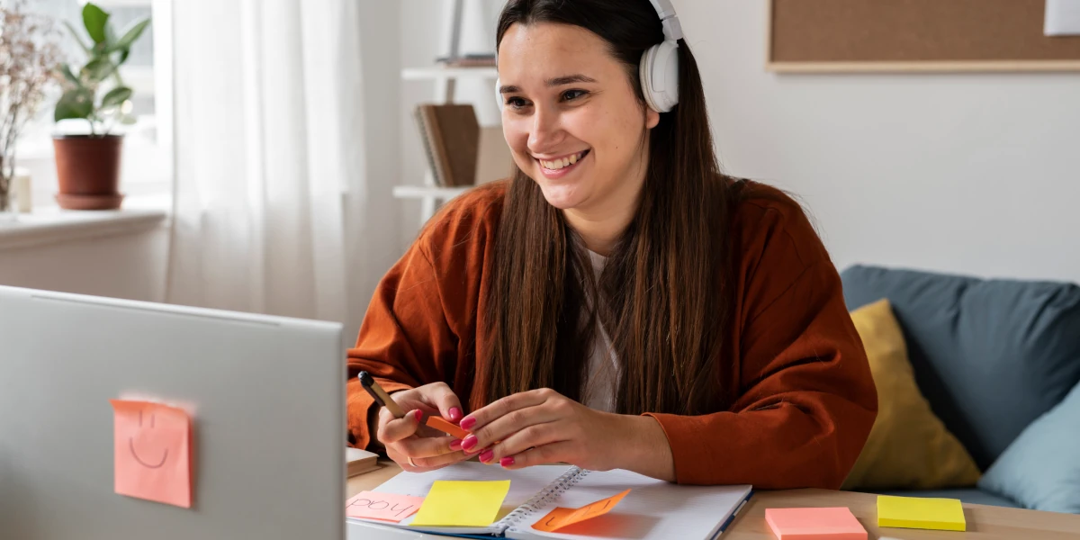 Girl working on laptop with headphones